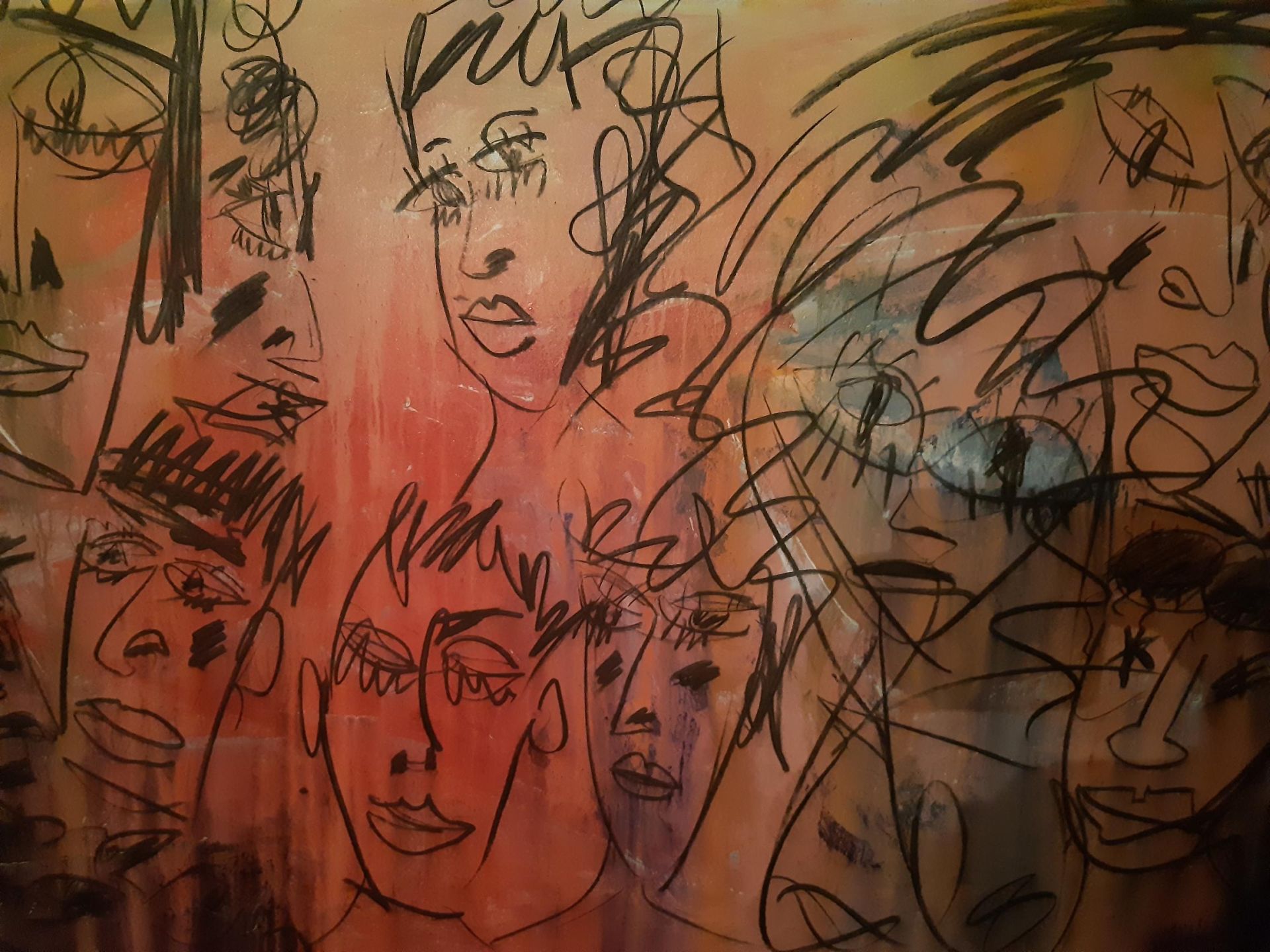 Porthcawl Artist Philip Vaughan Painting of a Red Background With Many Faces Drawn On It - 'At the Pary'